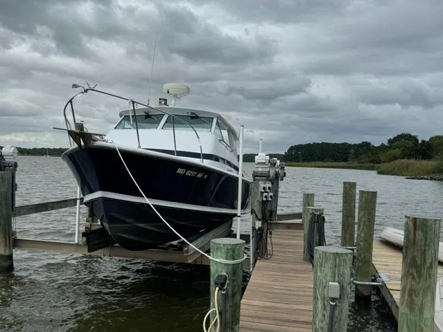 Slide: The Image of 1968 Bertram 31 Bahia Mar boat docked on a cloudy day. - 37