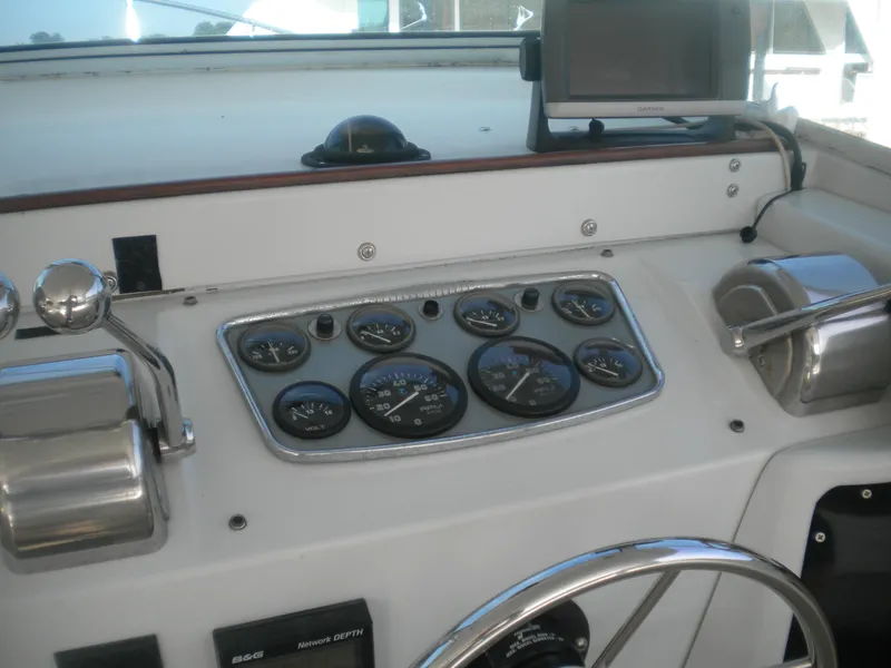 Slide: The Image of Control panel of a 1968 Bertram 31 Bahia Mar boat with gauges and steering wheel. - 4