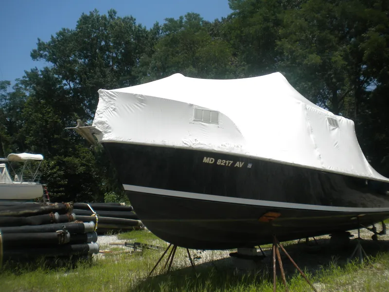 Slide: The Image of 1968 Bertram 31 Bahia Mar boat covered and stored outdoors on stands. - 43