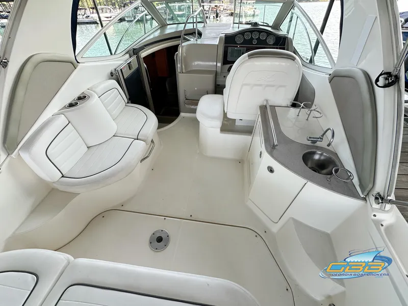Slide: The Image of 2006 Sea Ray 290 Sundancer boat interior with seating and helm. - 10