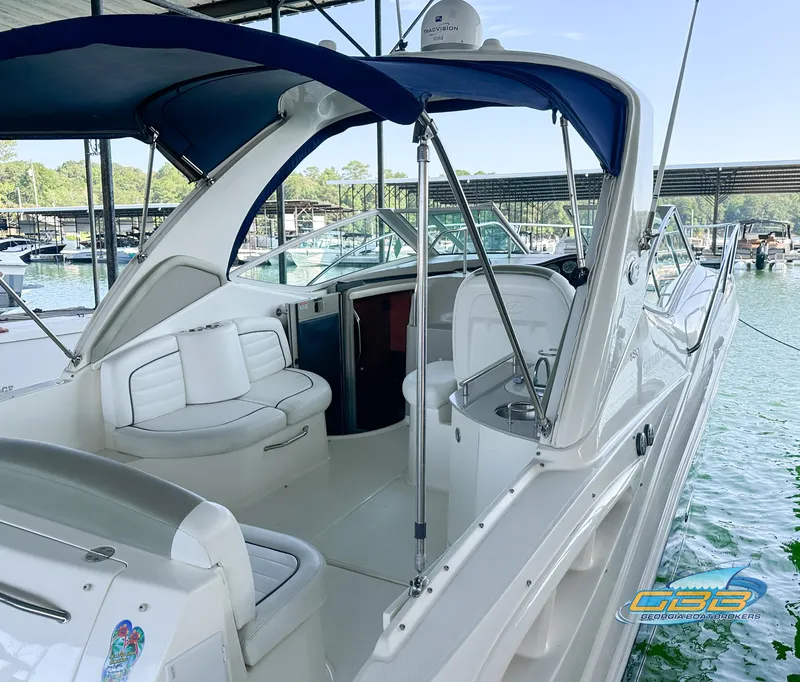 Slide: The Image of 2006 Sea Ray 290 Sundancer boat with blue canopy docked at marina. - 11