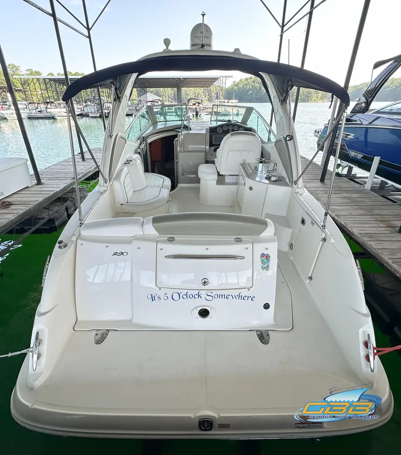 Slide: The Image of 2006 Sea Ray 290 Sundancer boat docked, featuring spacious seating and canopy. - 12