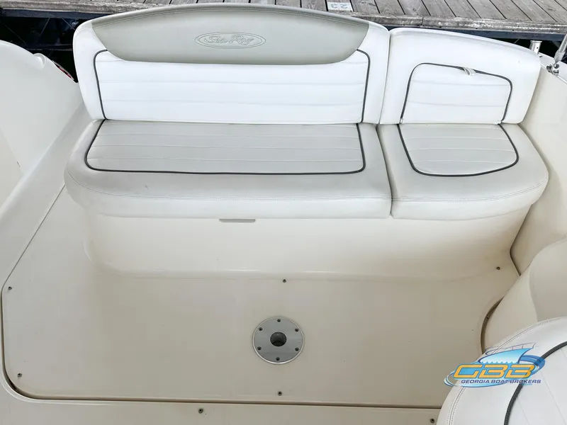 Slide: The Image of 2006 Sea Ray 290 Sundancer boat seating area with white and gray upholstery. - 14