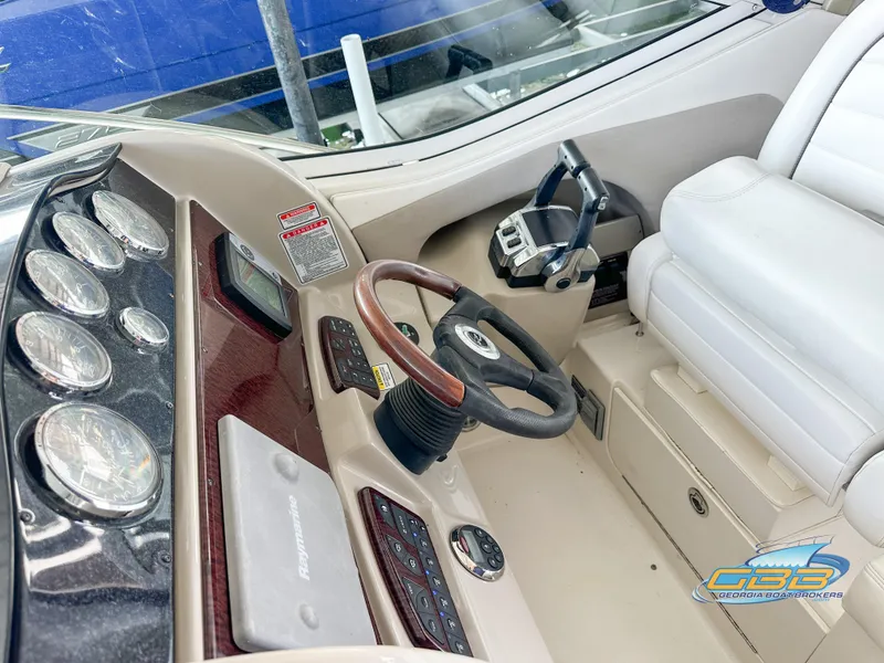 Slide: The Image of 2006 Sea Ray 290 Sundancer helm with gauges, steering wheel, and controls. - 17