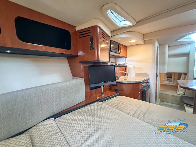 Slide: The Image of Interior of 2006 Sea Ray 290 Sundancer, featuring cozy seating and modern amenities. - 23