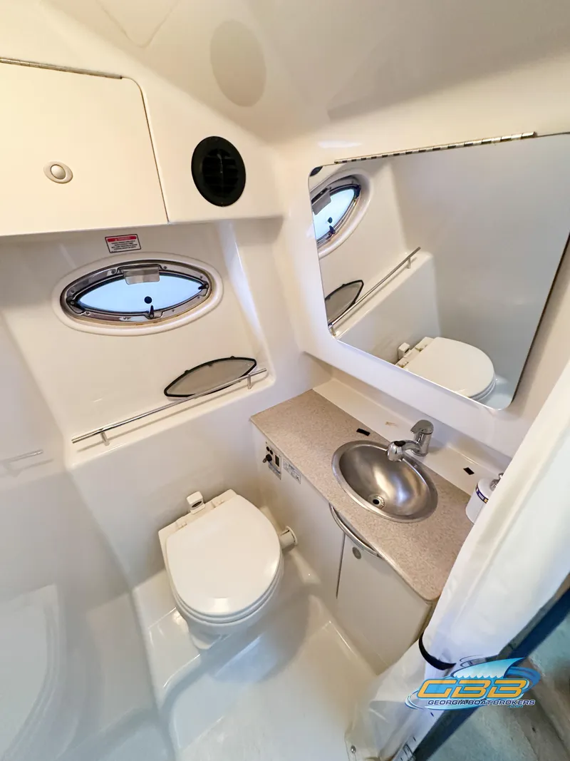 Slide: The Image of 2006 Sea Ray 290 Sundancer bathroom with sink, toilet, and mirror. - 29