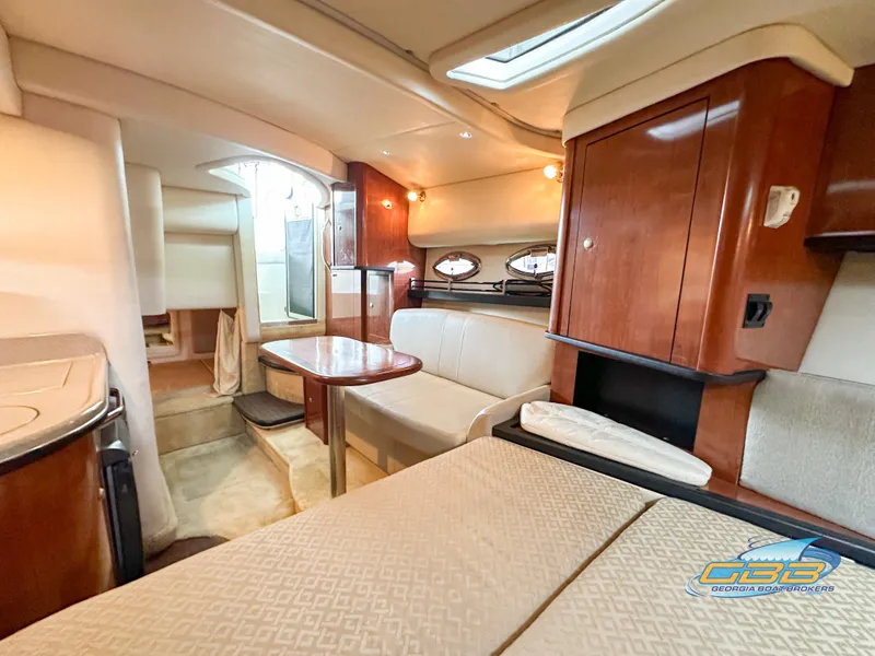 Slide: The Image of Interior of 2006 Sea Ray 290 Sundancer yacht with elegant wood finishes and cozy seating. - 32