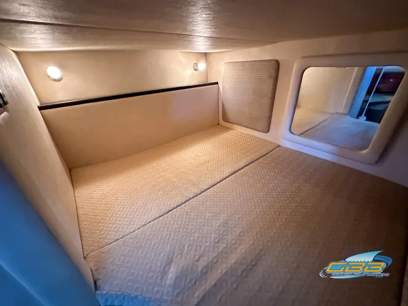 Slide: The Image of Interior cabin of 2006 Sea Ray 290 Sundancer with cozy bedding and soft lighting. - 37