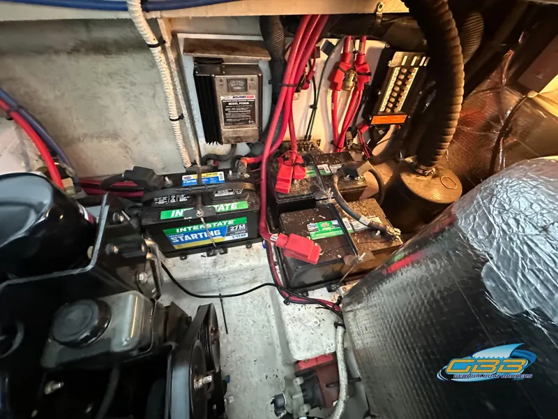 Slide: The Image of Engine compartment of a 2006 Sea Ray 290 Sundancer with batteries and wiring. - 38