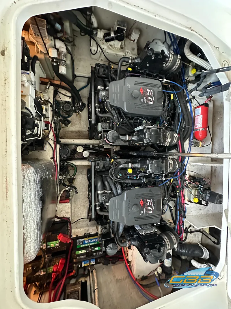 Slide: The Image of Engine compartment of a 2006 Sea Ray 290 Sundancer boat, showcasing dual engines and wiring. - 39