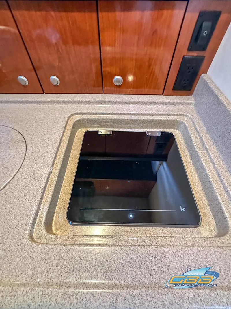 Slide: The Image of 2006 Sea Ray 290 Sundancer interior with sleek countertop and built-in stove. - 42