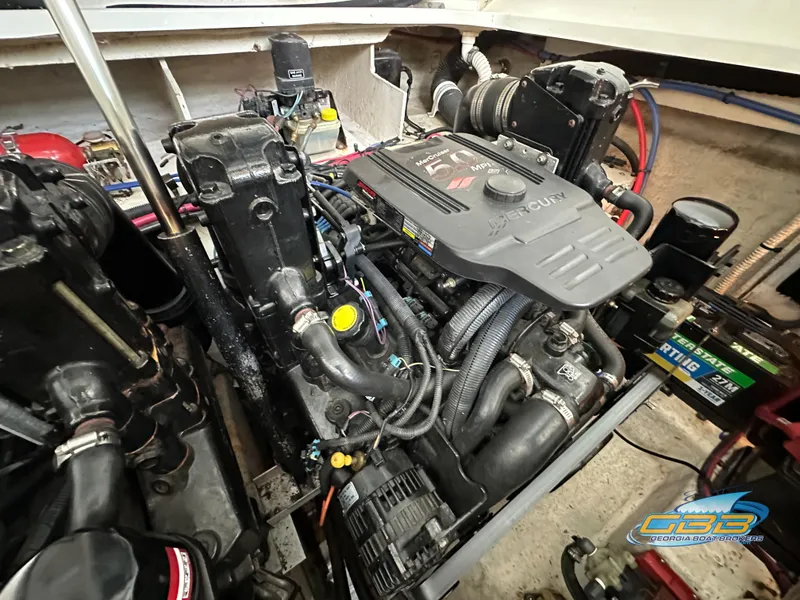 Slide: The Image of Engine compartment of a 2006 Sea Ray 290 Sundancer boat, showcasing detailed components. - 43
