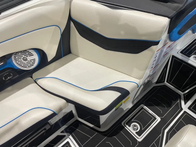 Slide: The Image of 2020 Centurion Ri237 boat interior with white and black seating, blue accents, and speaker. - 7