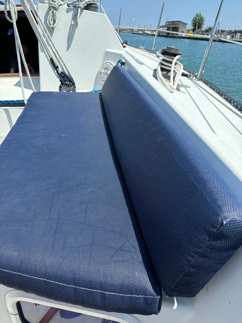 Slide: The Image of Blue cushioned seating on 1989 Ericson Yachts 34 sailboat deck. - 12