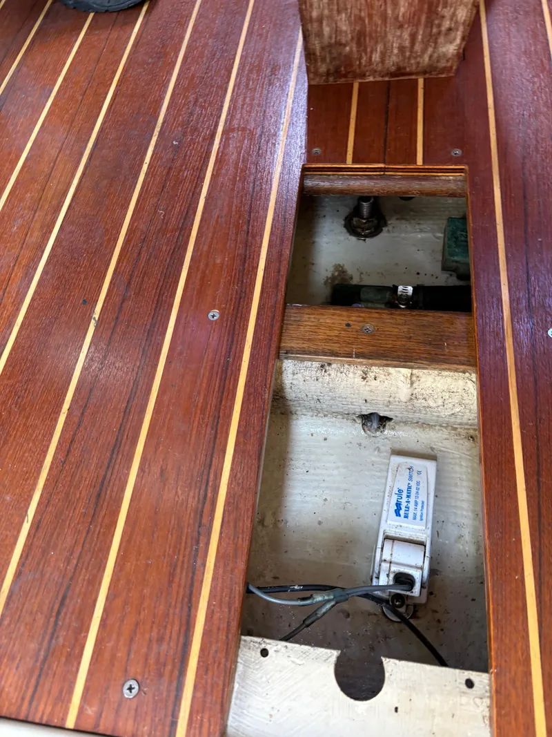 Slide: The Image of Open hatch on 1989 Ericson Yachts 34 wooden deck, revealing interior components. - 14