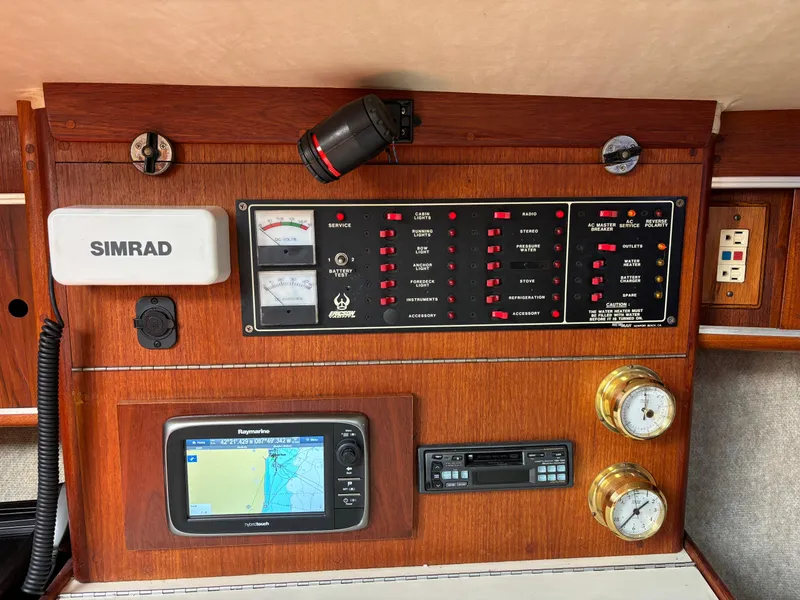 Slide: The Image of Control panel of a 1989 Ericson Yachts 34 with navigation and monitoring equipment. - 15