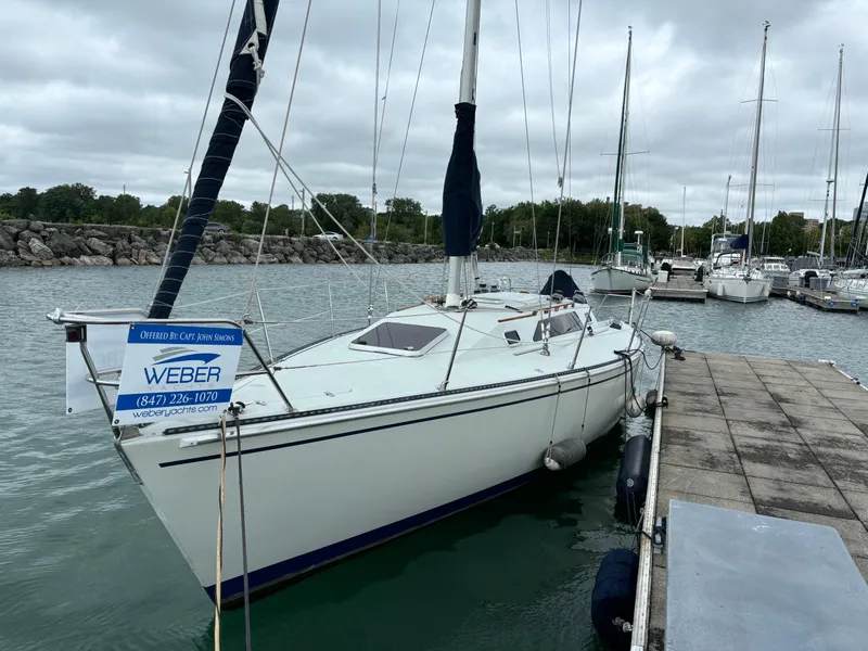 Slide: The Image of 1989 Ericson Yachts 34 sailboat docked at marina with overcast sky. - 2