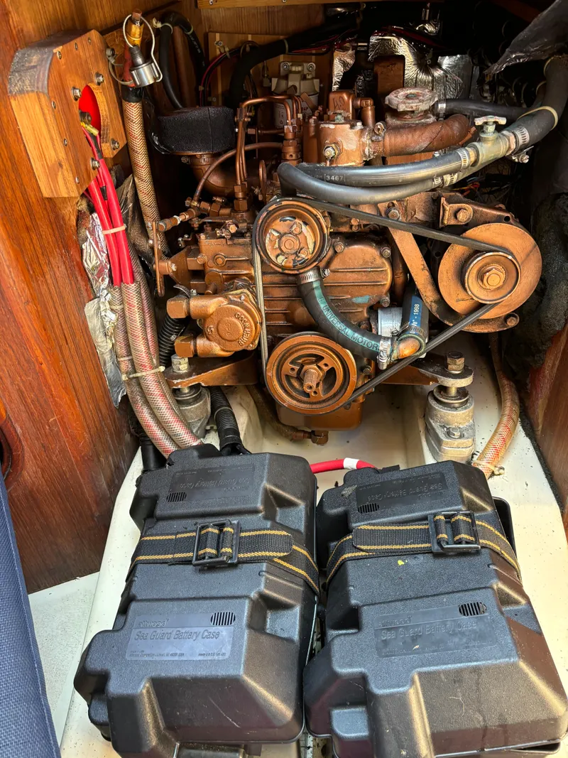 Slide: The Image of Engine compartment of a 1989 Ericson Yachts 34, featuring motor and battery cases. - 23