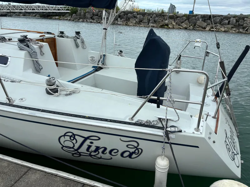 Slide: The Image of 1989 Ericson Yachts 34 sailboat docked, featuring elegant design and nautical equipment. - 3