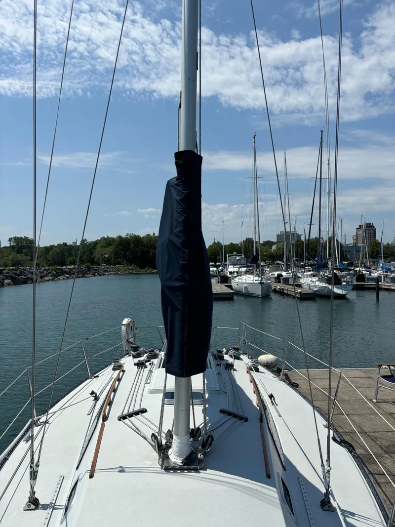 Slide: The Image of 1989 Ericson Yachts 34 sailboat docked at marina under blue sky. - 6