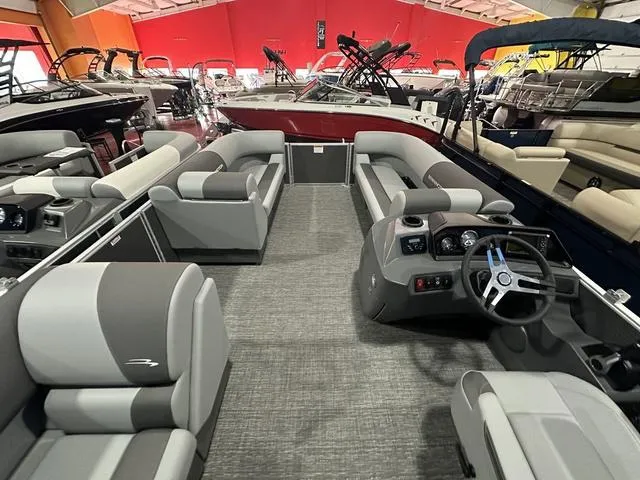 Slide: The Image of 2025 Bennington 21 SL pontoon boat interior with modern seating and steering console. - 10
