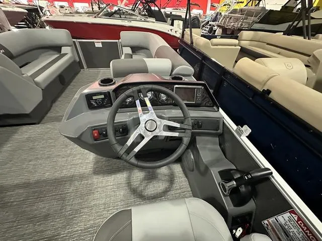 Slide: The Image of 2025 Bennington 21 SL boat interior with steering wheel and seating. - 11