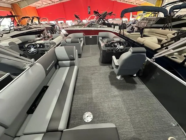 Slide: The Image of 2025 Bennington 21 SL pontoon boat interior with gray seating and modern dashboard. - 12