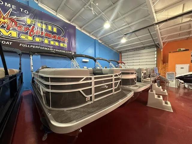 Slide: The Image of 2025 Bennington 21 SL pontoon boat displayed at Full Performance Marine showroom. - 3