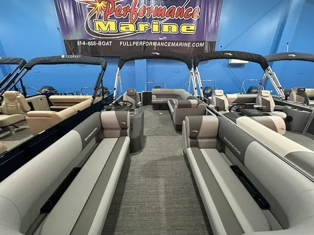 Slide: The Image of 2025 Bennington 21 SL pontoon boats displayed at Performance Marine showroom. - 4