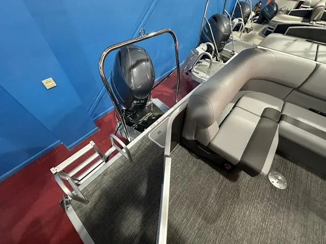 Slide: The Image of 2025 Bennington 21 SL pontoon boat interior with seating and motor. - 7