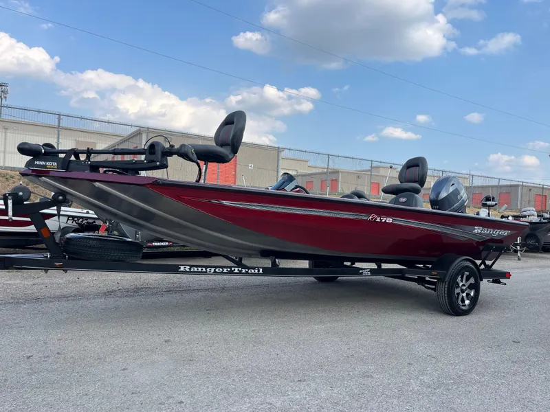 Slide: The Image of 2016 Ranger RT 178 Tournament Edition boat, red, on trailer, parked outdoors. - 2