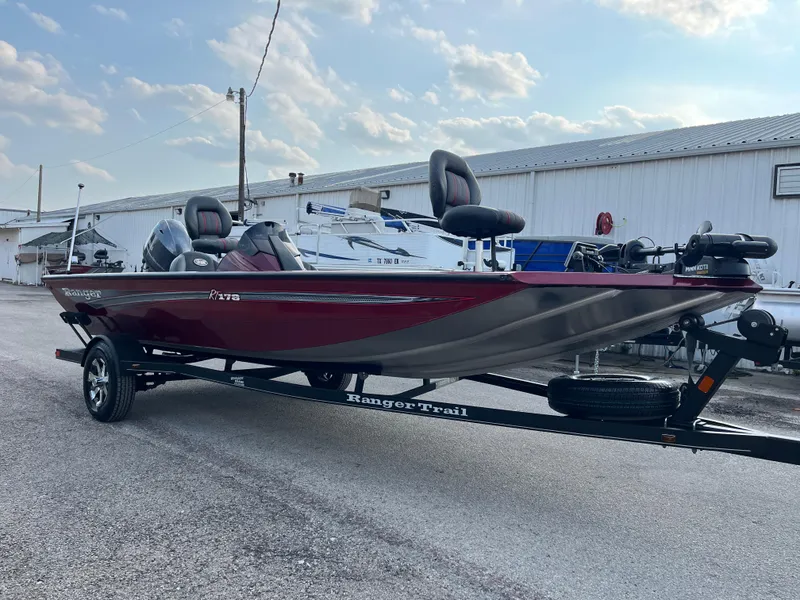 Slide: The Image of 2016 Ranger RT 178 Tournament Edition boat on trailer, red and silver, parked outdoors. - 27