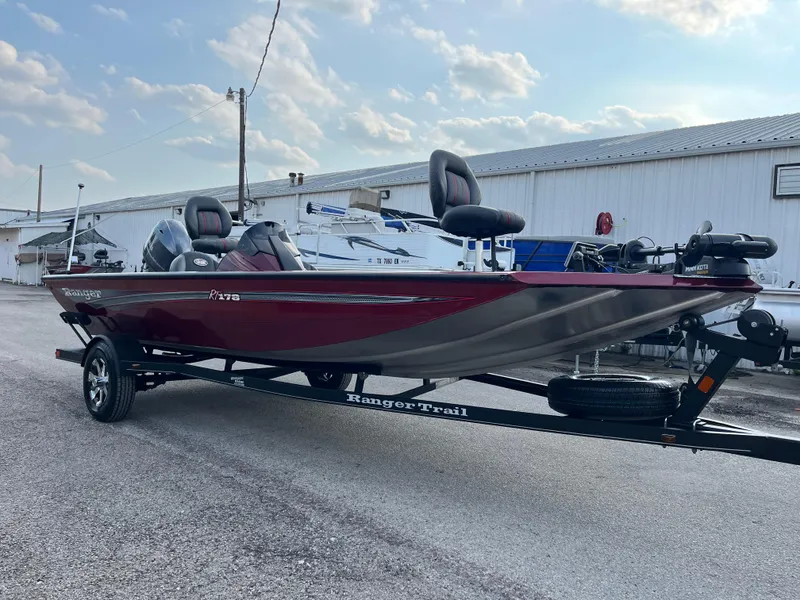 Slide: The Image of 2016 Ranger RT 178 Tournament Edition boat on trailer, red and silver, parked outdoors. - 3