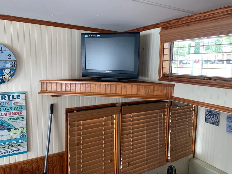 Slide: The Image of 1965 Lazy Days Custom interior with TV, wooden blinds, and nautical decor. - 10