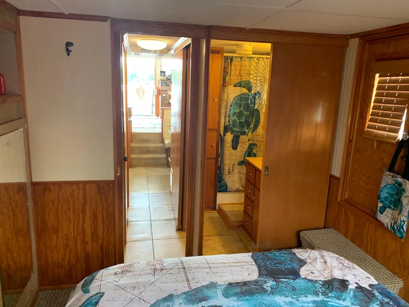 Slide: The Image of Interior of a 1965 Lazy Days Custom boat with turtle-themed decor and wood paneling. - 17