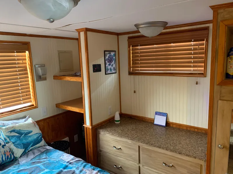Slide: The Image of 1965 Lazy Days Custom interior with wood accents, bed, drawers, and window blinds. - 18