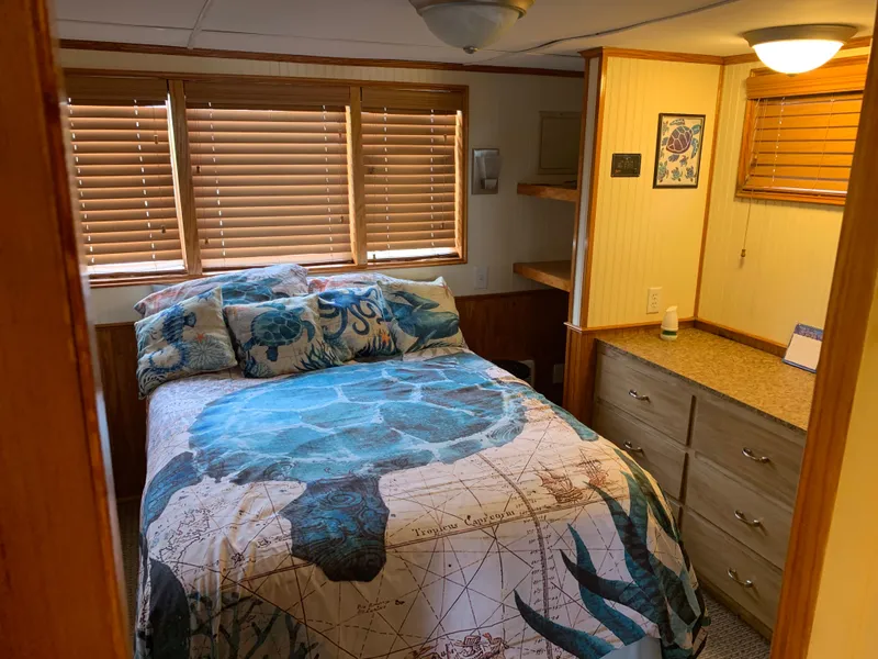 Slide: The Image of Cozy bedroom in 1965 Lazy Days Custom houseboat with turtle-themed bedding and wooden blinds. - 19