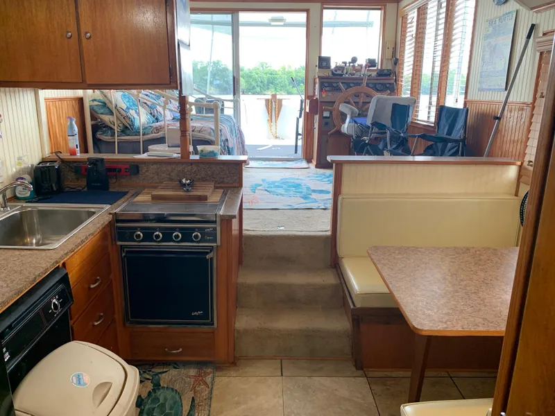 Slide: The Image of Interior of a 1965 Lazy Days Custom houseboat with kitchen and dining area. - 21