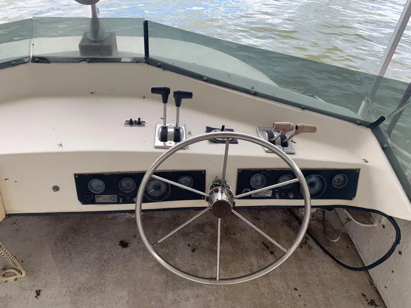 Slide: The Image of 1965 Lazy Days Custom boat helm with steering wheel and control panel on water. - 29