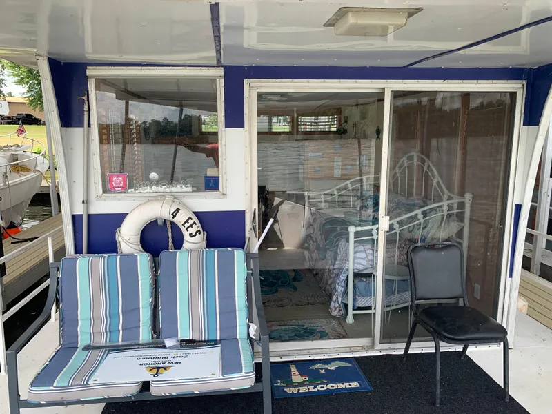 Slide: The Image of 1965 Lazy Days Custom houseboat with striped seating, sliding glass door, and interior view. - 3