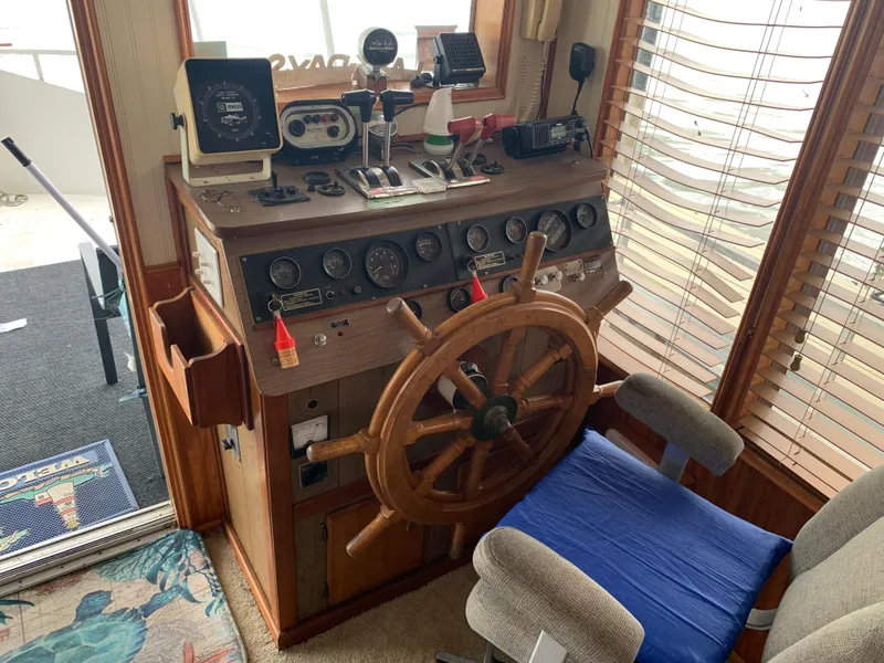 Slide: The Image of 1965 Lazy Days Custom boat helm with wooden wheel and vintage controls. - 6