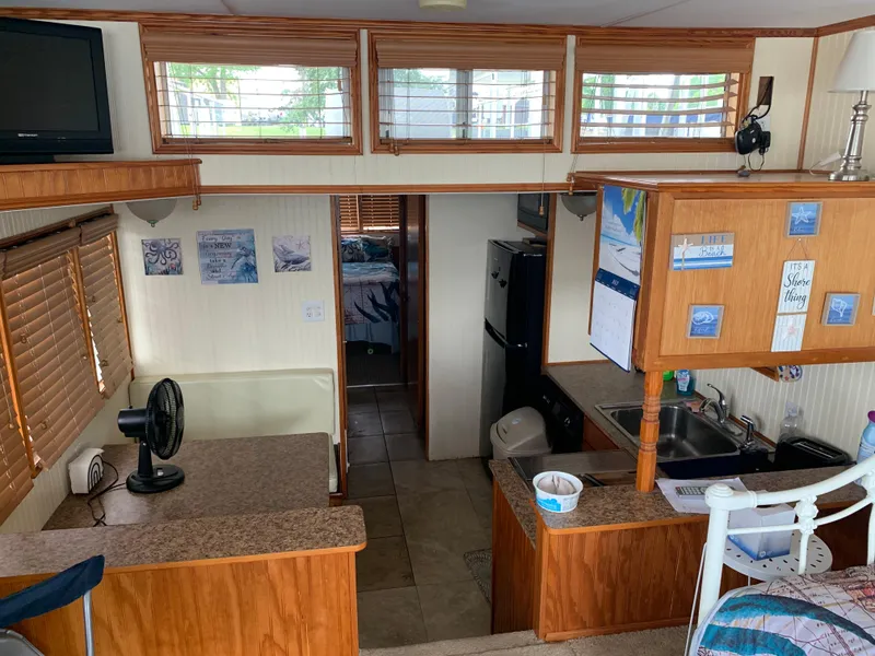 Slide: The Image of Interior of a 1965 Lazy Days Custom houseboat with kitchen and cozy living area. - 8