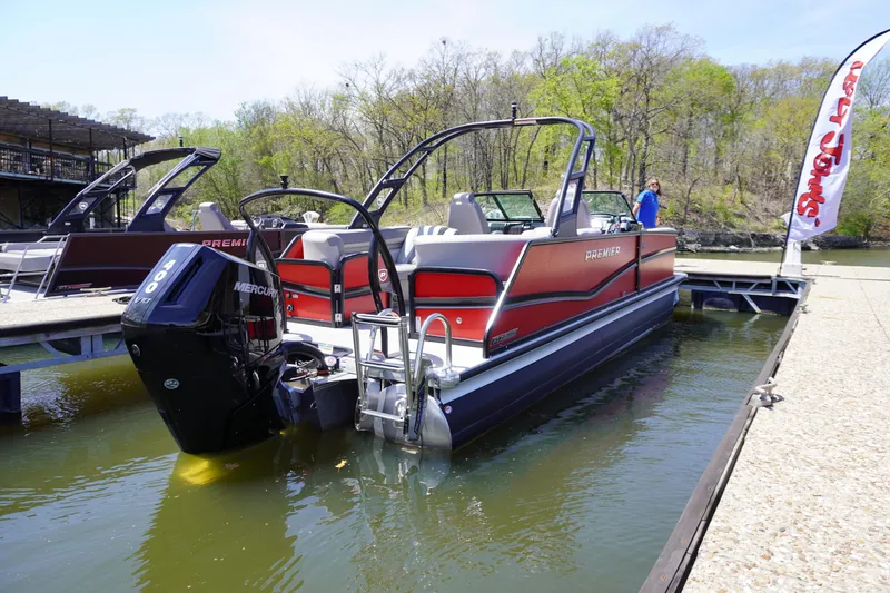 Slide: The Image of 2024 Premier 250 Solaris pontoon boat docked on a sunny day. - 1