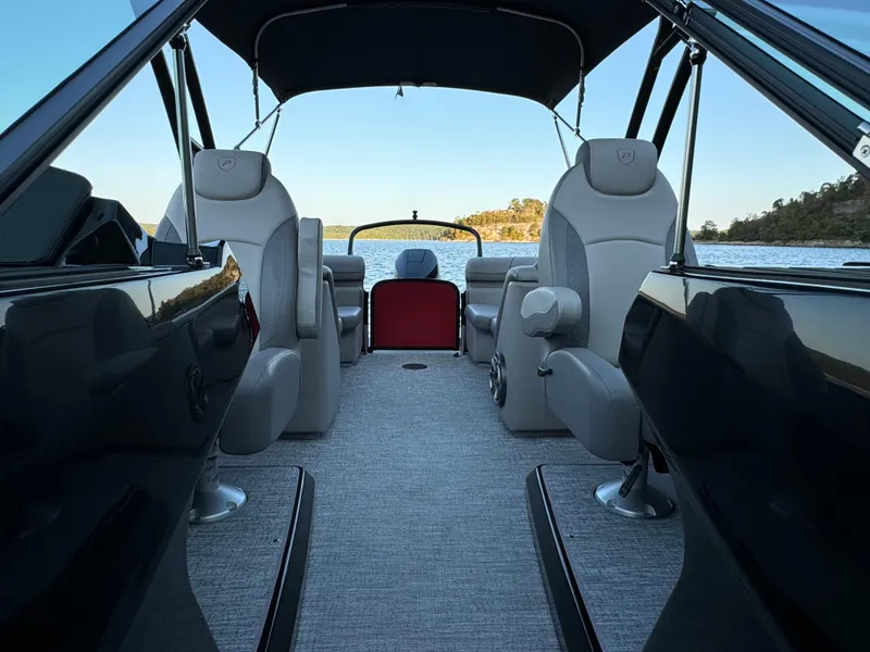 Slide: The Image of 2024 Premier 250 Solaris boat interior with luxurious seating, overlooking serene water. - 13