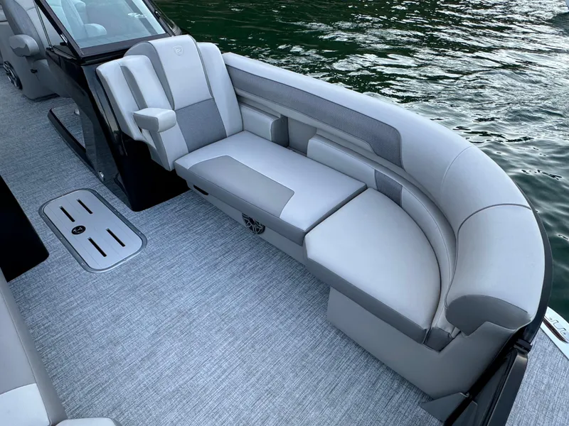 Slide: The Image of 2024 Premier 250 Solaris boat interior with luxurious seating and modern design on the water. - 18