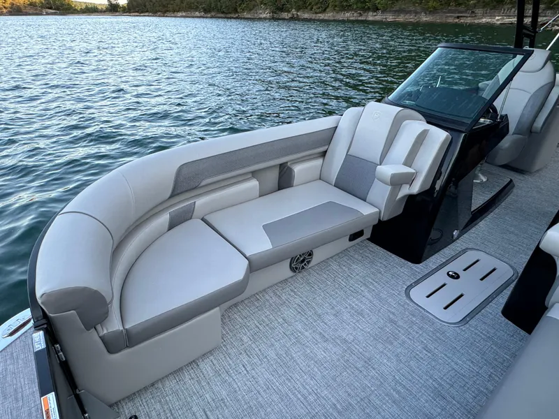 Slide: The Image of 2024 Premier 250 Solaris boat with luxurious seating on a serene lake. - 19