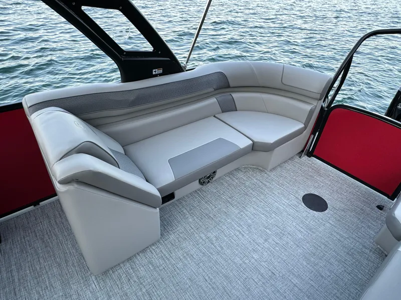 Slide: The Image of 2024 Premier 250 Solaris boat interior with gray seating and water view. - 22
