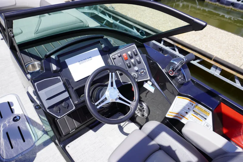 Slide: The Image of 2024 Premier 250 Solaris boat dashboard with steering wheel and control panel. - 4