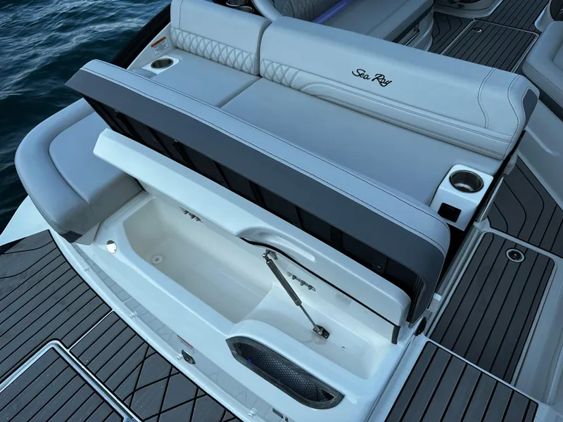 Slide: The Image of 2025 Sea Ray SLX 260 boat interior with open storage compartment and seating. - 14