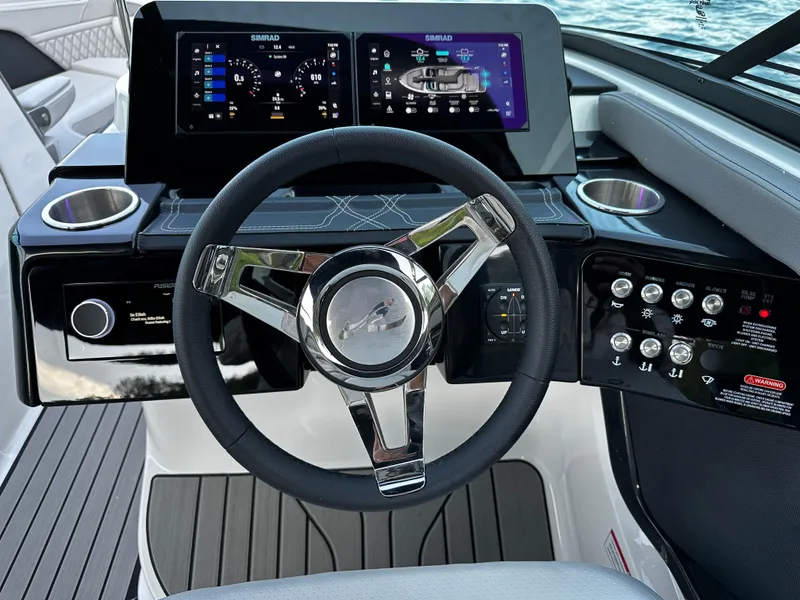Slide: The Image of 2025 Sea Ray SLX 260 dashboard with modern steering wheel and digital displays. - 15